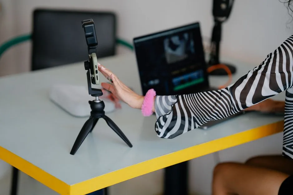 Creator comparing a video-editing workflow on a laptop and smartphone