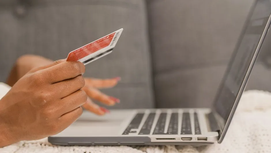 Person comparing subscription checkout details with a calculator beside a laptop