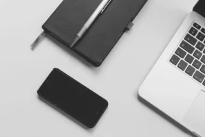 Person comparing subscription options on a laptop and smartphone
