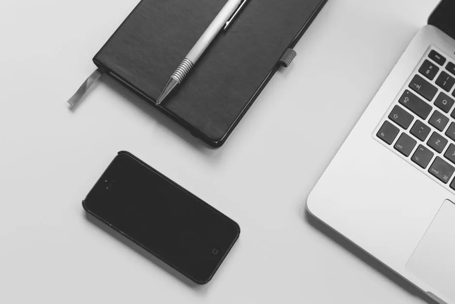 Person comparing subscription options on a laptop and smartphone
